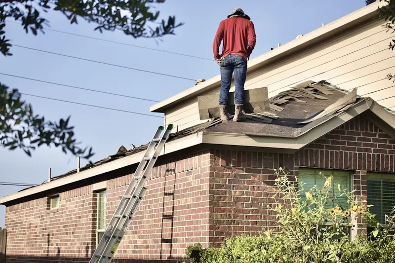 Professional roofer working on a residential roof in Kimball Junction